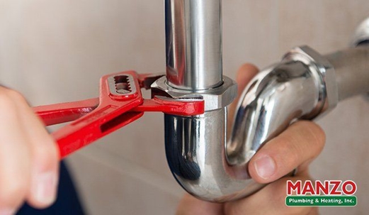 plumber using a wrench