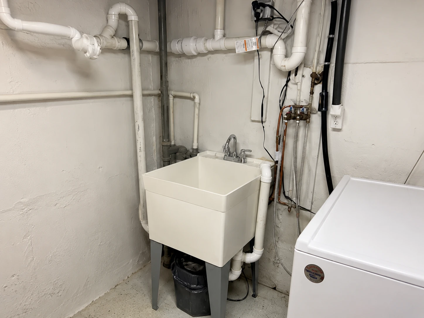 Utility room plumbing repairs and exposed piping by Manzo Plumbing on Long Island
